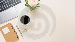 Office desk table with computer, supplies, flower and coffee cup. Top view with copy space