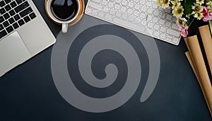 Office desk table with computer, supplies, flower and coffee cup. Top view with copy space