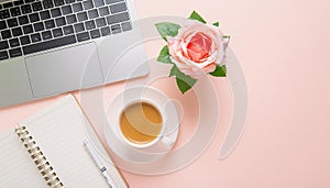 Office desk table with computer, supplies, flower and coffee cup. Top view with copy space