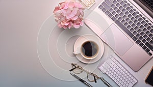 Office desk table with computer, supplies, flower and coffee cup. Top view with copy space