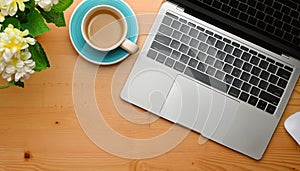 Office desk table with computer, supplies, flower and coffee cup. Top view with copy space