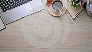 Office desk table with computer, supplies, flower and coffee cup. Top view with copy space