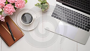 Office desk table with computer, supplies, flower and coffee cup. Top view with copy space