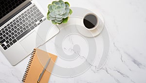 Office desk table with computer, supplies, flower and coffee cup. Top view with copy space