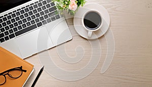 Office desk table with computer, supplies, flower and coffee cup. Top view with copy space