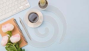 Office desk table with computer, supplies, flower and coffee cup. Top view with copy space