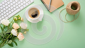 Office desk table with computer, supplies, flower and coffee cup. Top view with copy space