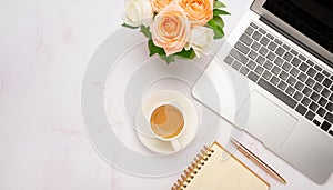 Office desk table with computer, supplies, flower and coffee cup. Top view with copy space