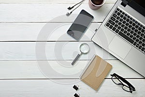 Office desk table with computer, supplies, flower. Top view. Copy space for text