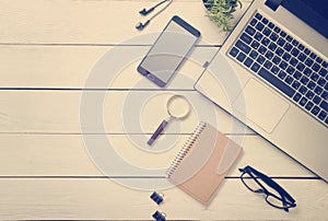 Office desk table with computer, supplies, flower. Top view. Copy space for text