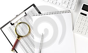 Office desk table with keyboard, notepad ,chart and calculator. Top view with copy space
