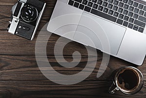 Office desk table with laptop,camera and coffee. Top view, flat lay