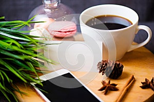 Office desk table with smartphone, pen on notebook, name card, cup of coffee and flower. Top view with copy space.