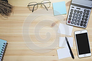 Office desk table supplies notebook, smart phone, Eye glasses and Calculator. Top view with copy space