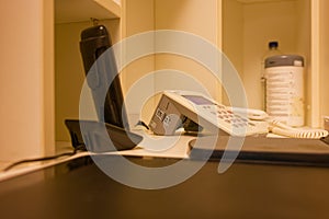 Office desk with telephone handset and calculator in a workspace environment