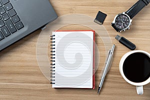 Office Desk Top view Workplace With Wooden Desk, Laptop, Notepad, Pen and Dark Hot Coffee