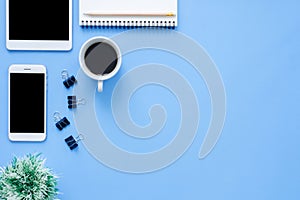 Office desk working space - Flat lay top view mockup photo of working space with tablet, phone, coffee cup and notebook.