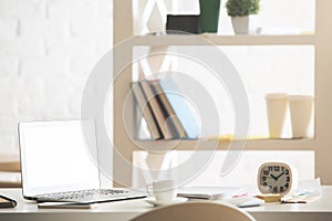 Office desktop with white laptop