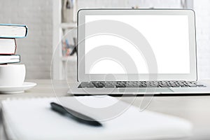 Office desktop with white laptop