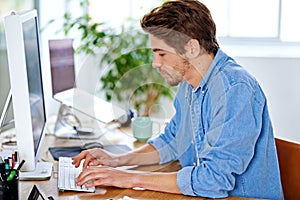 Office, employee and man with keyboard, computer and technology for job, networking and internet. Creative, male person