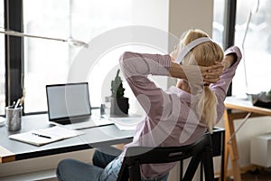 Office employee resting on chair, enjoying work break