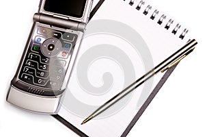 Office equipment concept - spiral notebook, pen and modern phone