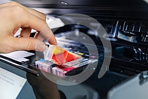 Office equipment maintenance and service - hand replace inkjet printer cartridge photo