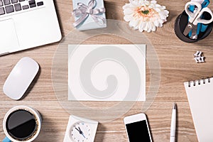 Office equipment such as computer keyboard, mouse, sheet of paper and pen on office wooden desk with coffee