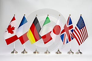 Office flags of the countries of the G7 block on a light background. Summit of USA, UK, Japan, Italy, Germany, France photo