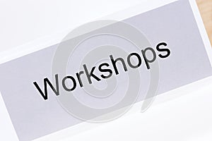 Office folder with the label workshops