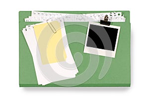 Office file folder untidy torn notepaper and yellow post-it style sticky note, blank polaroid photo frame