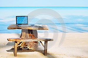 Office of freelancer on the beach, laptop computer with empty screen