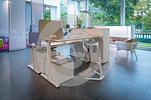 In office furniture exhibition there is a white height-adjustable desk combination