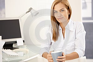 Office girl enjoying coffee break