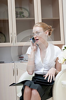 Office girl talking on mobile phone