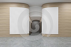 Office hall with rounded wooden walls. There are two white posters on them.