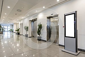 Office hallway with elevator and advertising screen