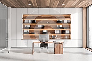 Office interior with table and computer, shelf with folders and panoramic window