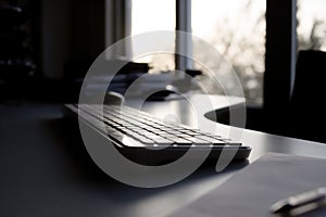 Office Keyboard with Sunset View Through Window