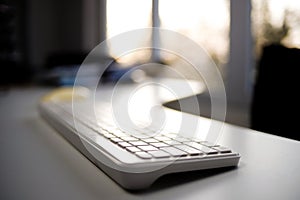 Office Keyboard with Sunset View Through Window