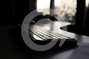 Office Keyboard with Sunset View Through Window