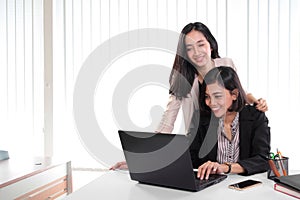 Office ladies working with laptop together