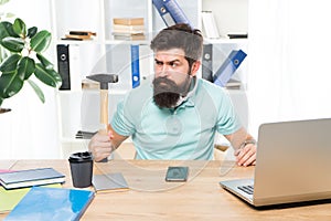 Office life makes him crazy. Businessman with beard and mustache gone mad with hammer in a hand. Angry aggressive