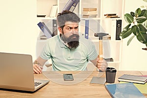 Office life makes him crazy. Businessman with beard and mustache gone mad with hammer in a hand. Angry aggressive