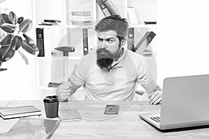 Office life makes him crazy. Businessman with beard and mustache gone mad with hammer in a hand. Angry aggressive