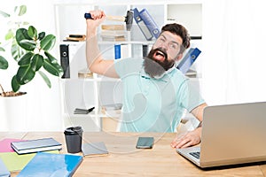 Office life makes him crazy. Businessman with beard and mustache gone mad with hammer in a hand. Frustrated office