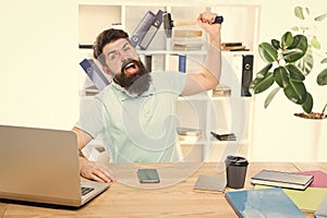 Office life makes him crazy. Businessman with beard and mustache gone mad with hammer in a hand. Frustrated office
