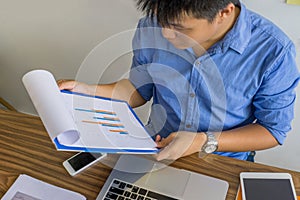 Office man checking financial report at the workplace