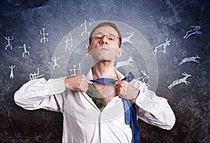 The office man opens his white shirt and shows the primitive hide. Against the background of primitive drawings on a rough rock