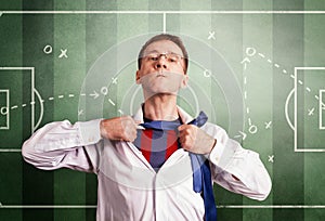 The office man opens a white shirt and shows a football form. Against the background of the coaching scheme of the match